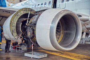 Technicians working on a jet engine.