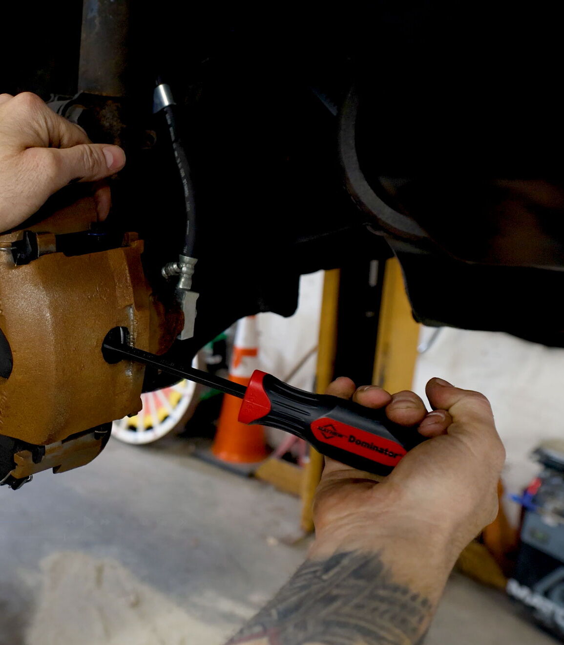 Mayhew dominator pry bar used on a automotive brake pads casing.